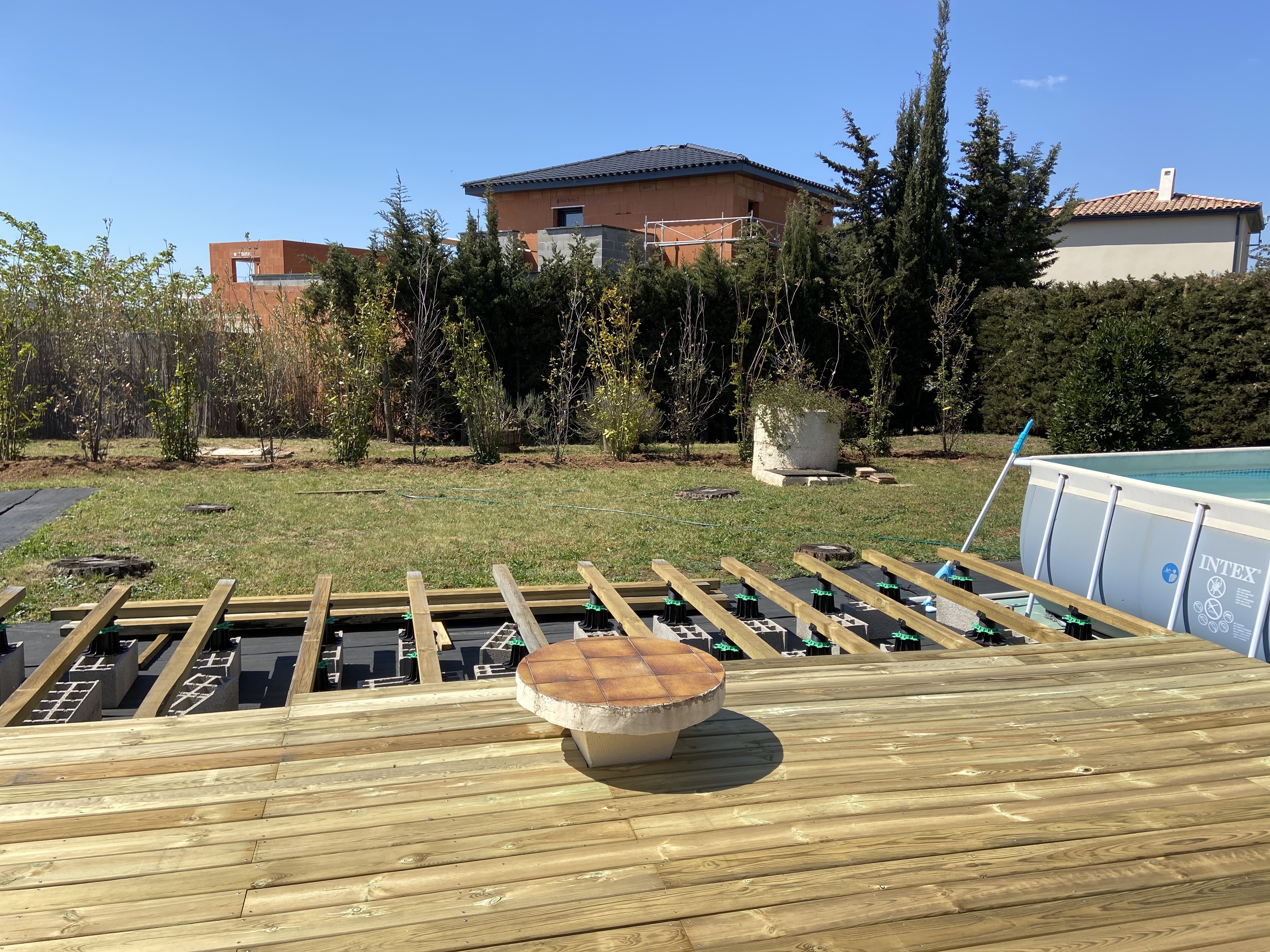 Building the second 10m by 4m decking section is almost complete. The fairy circle table becomes a feature. We replaced the old inflatable pool which a local cat punctured with a larger one. We planted 14 trees to hide the hideous new builds behind us.